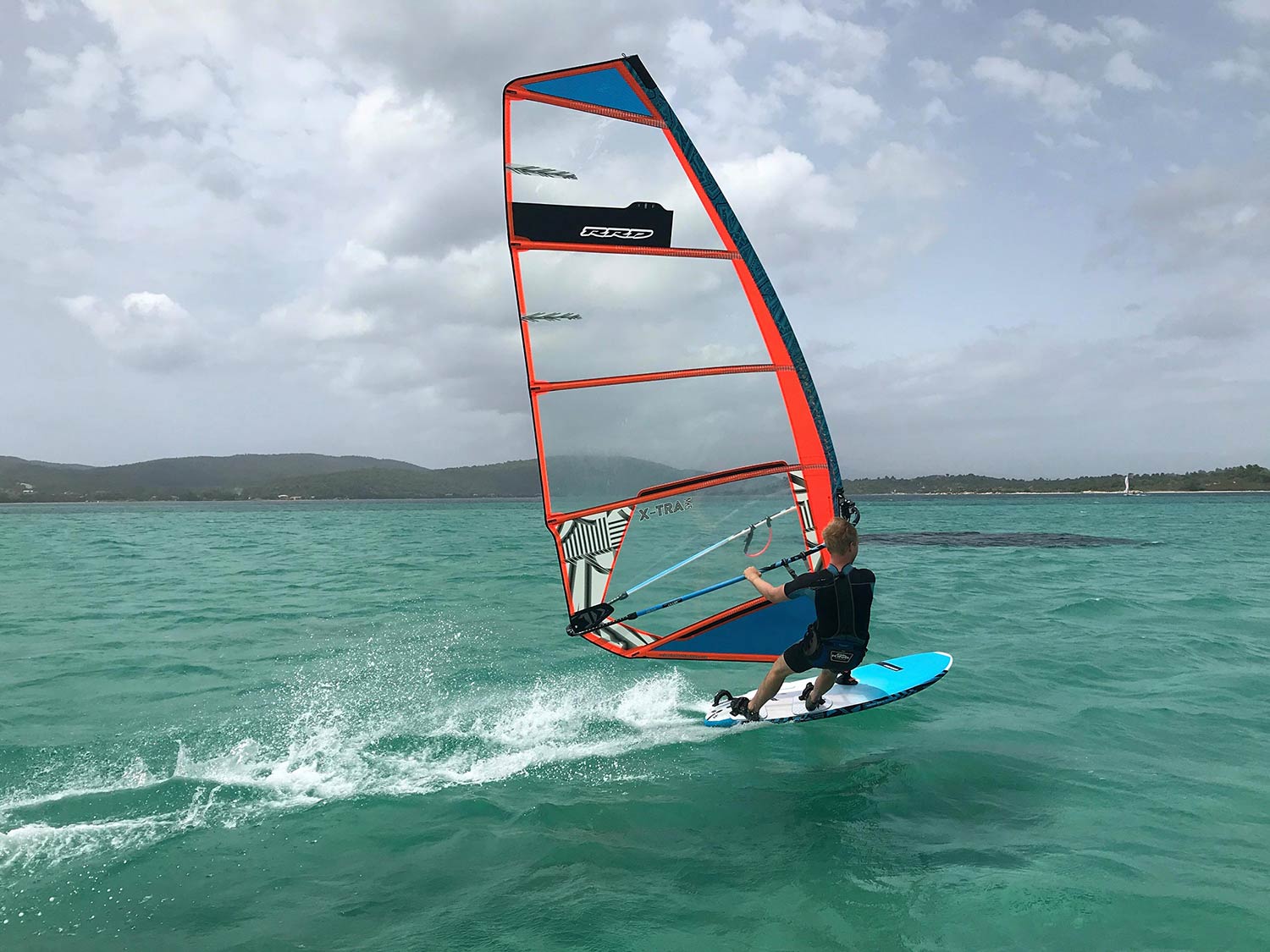 Person windsurfing on a windy day